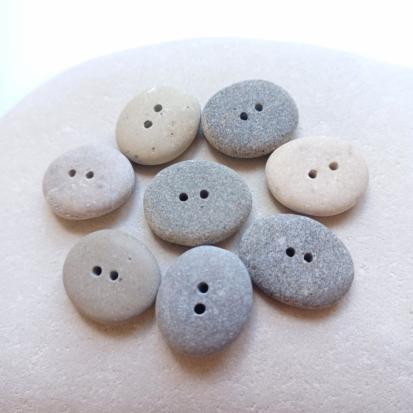 Buttons made from beach pebbles.
