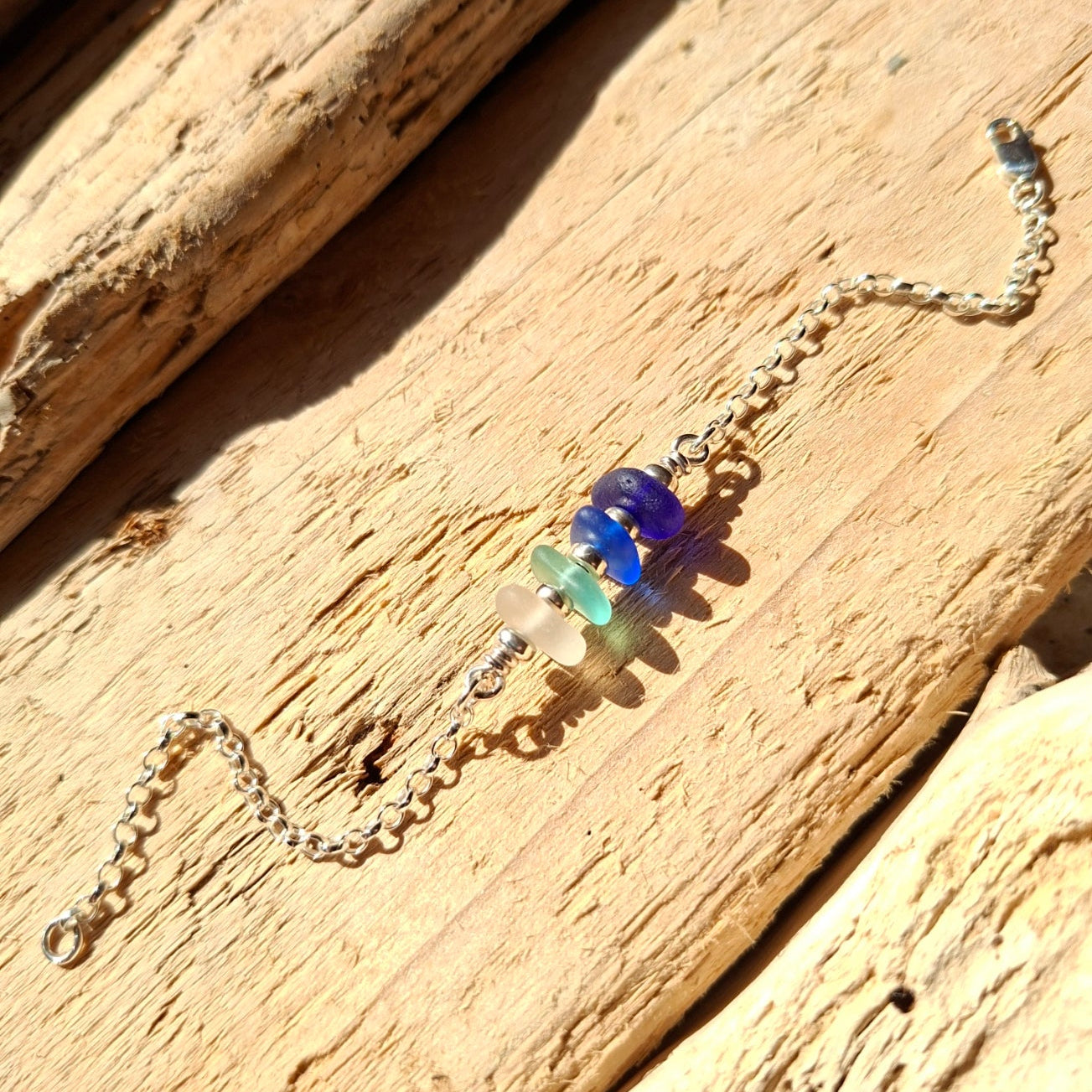 Silver bracelet with shades of blue sea glass, made in Cyprus.
