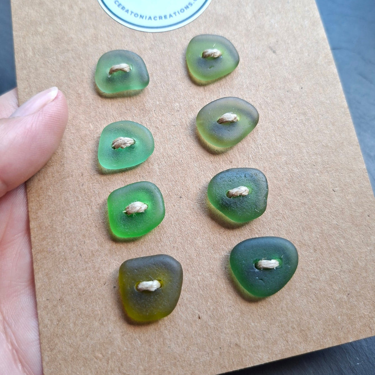 Sea glass buttons in various shades of coastal green.