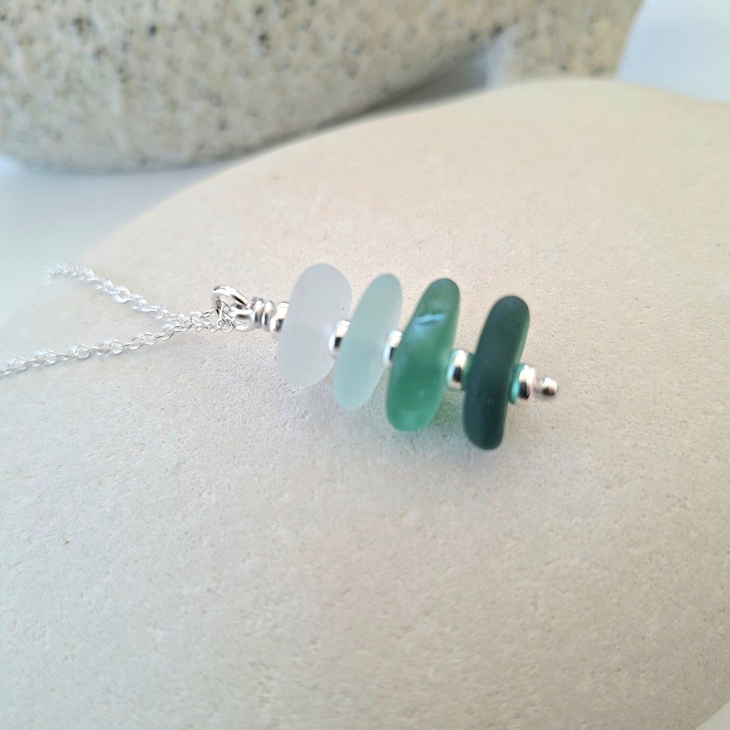 Silver necklace with a pendant made with 4 pieces of sea glass in coastal shades.