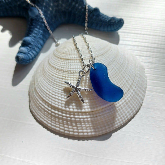 Silver necklace with a cobalt blue sea glass pendant and starfish charm.