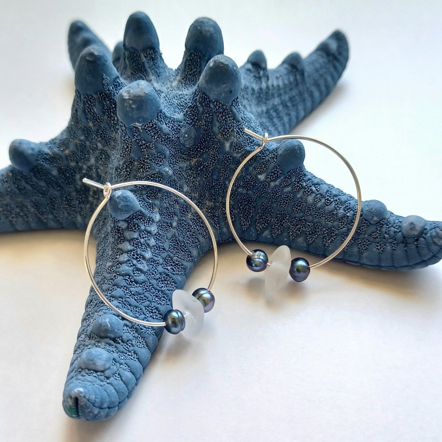 Silver hoops with peacock pearls and white sea glass.