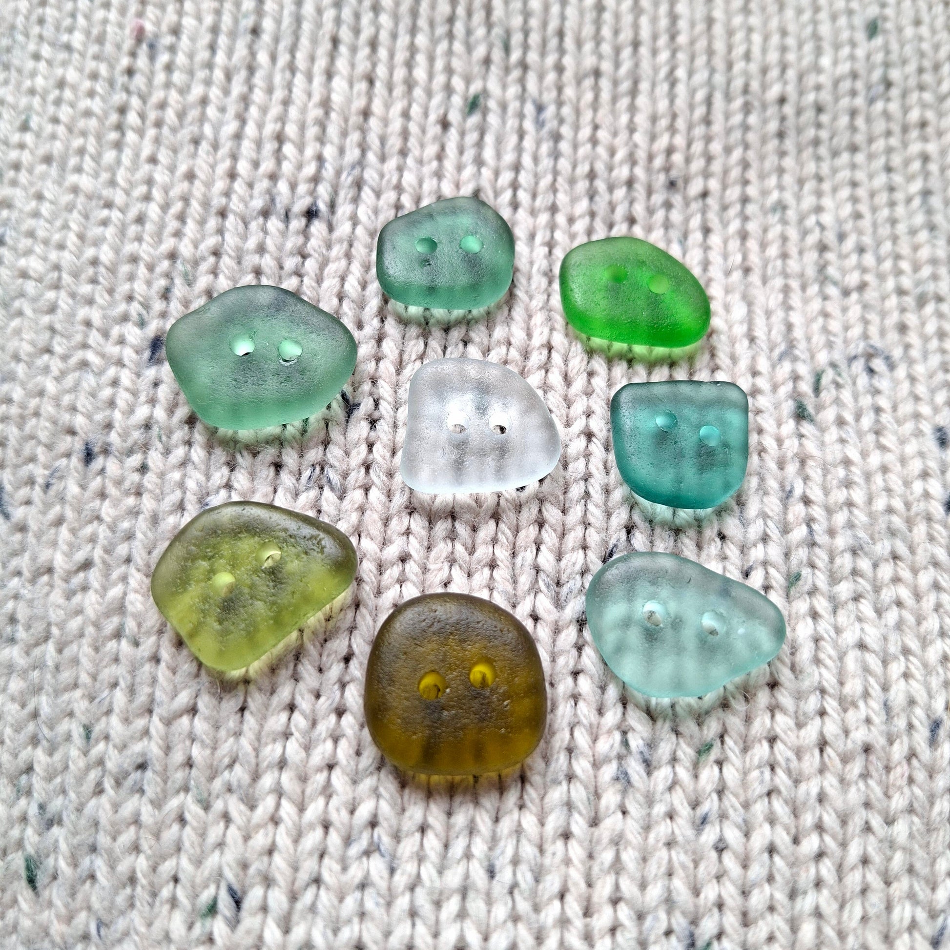 A set of eight sea glass buttons in coastal colours, made in Cyprus.