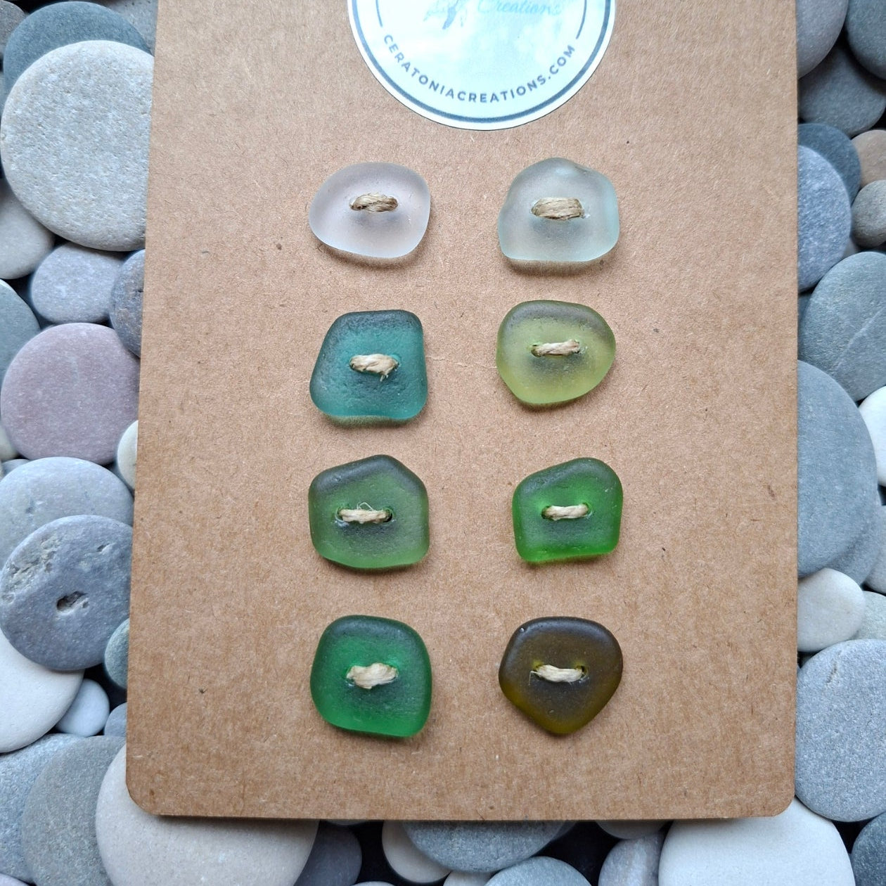A set of eight sea glass buttons in various coastal colours.