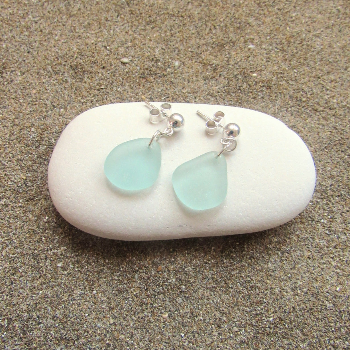 A pair of sterling silver sea foam sea glass drop earrings. 