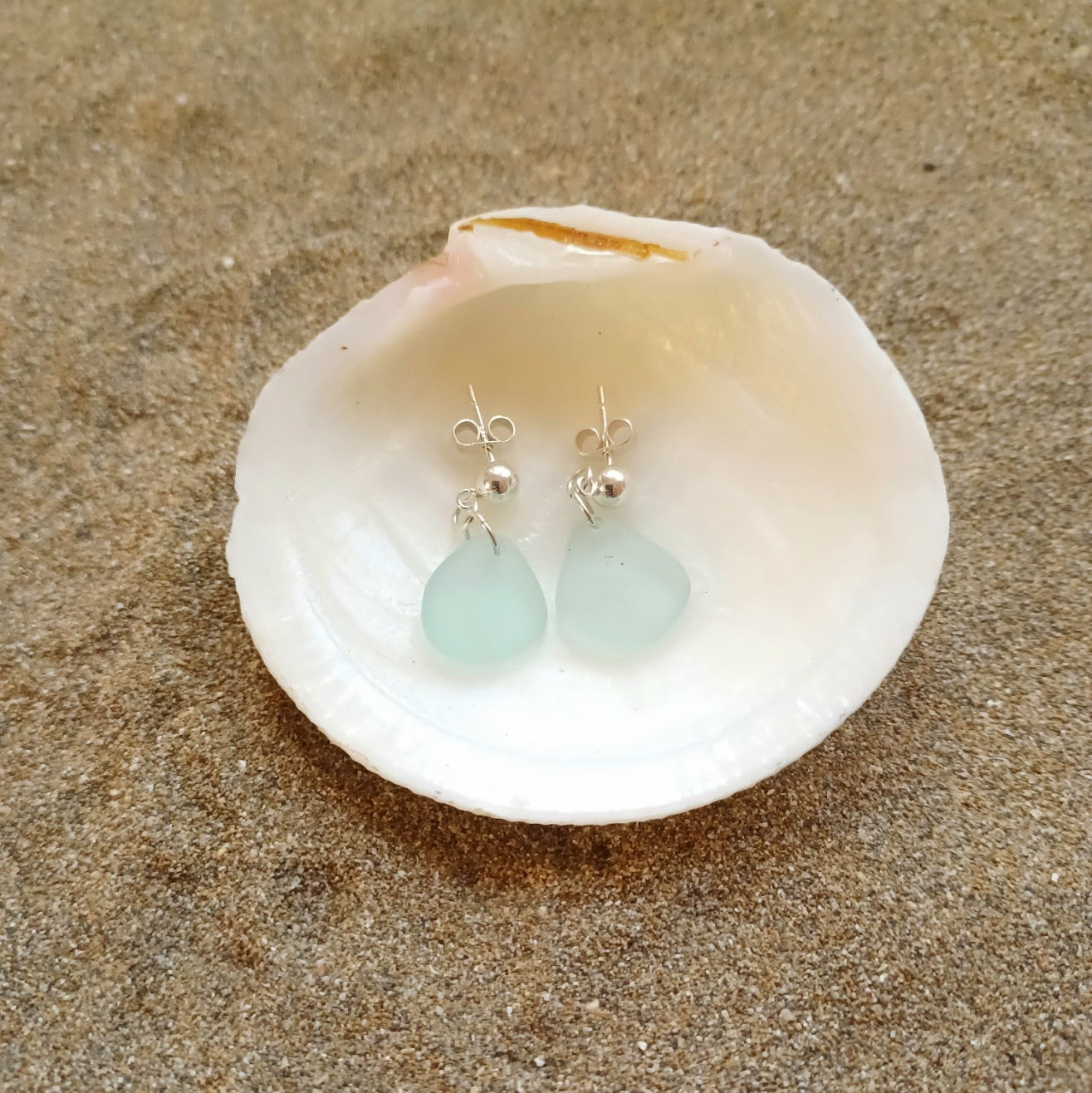 A pair of sterling silver sea foam sea glass drop earrings. 